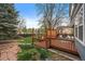 Backyard wooden deck with chairs and a privacy screen, creating a cozy and inviting outdoor living space at 8508 Vivian Ct, Arvada, CO 80005