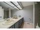 Modern bathroom with double vanity, neutral tiling and shower-tub combination at 8508 Vivian Ct, Arvada, CO 80005