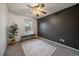 This is a cozy bedroom with a ceiling fan, a window, and a bench at 8508 Vivian Ct, Arvada, CO 80005