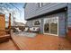 Back deck area showcasing outdoor seating, a patio rug, and sliding glass doors to the home at 8508 Vivian Ct, Arvada, CO 80005