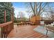 A spacious wooden deck features built-in benches, comfortable seating, and string lights at 8508 Vivian Ct, Arvada, CO 80005