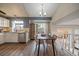 Eat-in kitchen and dining area features stainless appliances and a charming dining set next to the staircase at 8508 Vivian Ct, Arvada, CO 80005