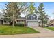 Charming two-story home features a well-manicured lawn, attached garage and delightful yellow front door at 8508 Vivian Ct, Arvada, CO 80005