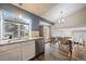 Well-lit kitchen features a window view and stainless steel appliances alongside a dining area at 8508 Vivian Ct, Arvada, CO 80005