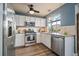 Bright kitchen features stainless steel appliances, granite countertops and white cabinets at 8508 Vivian Ct, Arvada, CO 80005