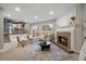 Open-concept living room features a brick fireplace and seamless flow to the kitchen and outdoor deck at 8508 Vivian Ct, Arvada, CO 80005