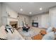 Cozy living room showcasing a brick fireplace, plush seating, and ample natural light at 8508 Vivian Ct, Arvada, CO 80005