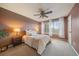 Comfortable main bedroom features soft carpet, a ceiling fan and large windows offering plentiful natural light at 8508 Vivian Ct, Arvada, CO 80005
