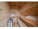Interior view of the wooden sauna featuring benches, a towel, and a heater at 8508 Vivian Ct, Arvada, CO 80005