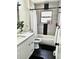 Modern bathroom with gray tile, sleek fixtures, and a shower-tub combination at 1528 Coronado Pkwy, Denver, CO 80229