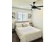 Bright bedroom with a large window, ceiling fan, and neutral decor at 1528 Coronado Pkwy, Denver, CO 80229