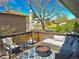 Relaxing outdoor deck featuring comfortable seating, a fire pit, and scenic neighborhood views at 1528 Coronado Pkwy, Denver, CO 80229
