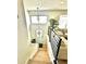 Welcoming front foyer with hardwood stairs, natural light, and views into the spacious living room at 1528 Coronado Pkwy, Denver, CO 80229