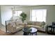 Bright and airy living room featuring neutral tones, comfortable sofas, and plenty of natural light at 1528 Coronado Pkwy, Denver, CO 80229