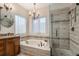 Spacious bathroom with soaking tub, glass enclosed shower, and double sinks at 11613 W Coal Mine Dr, Littleton, CO 80127