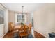 Bright dining area with a wooden table, hardwood floors, and a large window at 11613 W Coal Mine Dr, Littleton, CO 80127