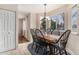 Cozy dining room with natural light, hardwood floors, and traditional furnishings at 11613 W Coal Mine Dr, Littleton, CO 80127