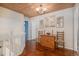 Inviting hallway featuring hardwood floors, wood ceiling, and natural light at 11613 W Coal Mine Dr, Littleton, CO 80127