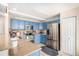 Well-equipped kitchen featuring blue cabinetry, stainless steel appliances, and stone countertops at 11613 W Coal Mine Dr, Littleton, CO 80127