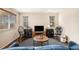 Well-lit living room with a modern entertainment center and stylish decor, creating a welcoming space at 11613 W Coal Mine Dr, Littleton, CO 80127