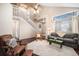 Open-concept living room featuring a vaulted ceiling, hardwood floors, and a large window at 11613 W Coal Mine Dr, Littleton, CO 80127