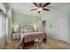 Calm bedroom with large window, a comfortable bed, and ceiling fan at 11613 W Coal Mine Dr, Littleton, CO 80127