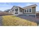 Exterior view of backyard including lawn, rock garden, and covered porch at 14881 Chicago St, Parker, CO 80134