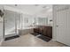 Bright bathroom featuring a glass shower, soaking tub, and double vanity sinks at 14881 Chicago St, Parker, CO 80134