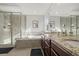 Bathroom featuring a glass shower, soaking tub, and double vanity at 14881 Chicago St, Parker, CO 80134