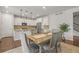 Open dining area next to the modern kitchen with pendant lighting, neutral walls, and access to the backyard at 14881 Chicago St, Parker, CO 80134