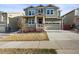 Inviting two-story home with a covered porch, attached garage, and well-maintained lawn in a suburban neighborhood at 14881 Chicago St, Parker, CO 80134