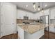 Open kitchen with granite counters, stainless appliances, and white cabinets at 14881 Chicago St, Parker, CO 80134