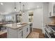 Bright kitchen island with stainless steel appliances, pendant lights, granite countertops, and hardwood flooring at 14881 Chicago St, Parker, CO 80134