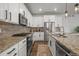 Modern kitchen featuring stainless steel appliances, granite countertops, and stylish white cabinetry at 14881 Chicago St, Parker, CO 80134