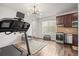 Kitchenette featuring stainless steel appliances, hardwood floors, and adjacent treadmill at 14881 Chicago St, Parker, CO 80134