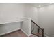 Landing area featuring built-in desk space and wood railing on stairs at 14881 Chicago St, Parker, CO 80134