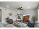 Comfortable living area featuring a modern fireplace, hardwood flooring, and a stylish ceiling fan at 14881 Chicago St, Parker, CO 80134