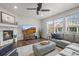 Cozy living room with a stone fireplace, a mounted TV, hardwood flooring, and neutral paint colors at 14881 Chicago St, Parker, CO 80134