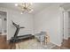 Living space featuring hardwood floors, exercise equipment and modern lighting at 14881 Chicago St, Parker, CO 80134