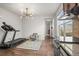 Living space adjacent to kitchenette featuring hardwood floors, and adjacent treadmill at 14881 Chicago St, Parker, CO 80134