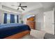 Spacious main bedroom featuring a tray ceiling, ceiling fan, and a large window at 14881 Chicago St, Parker, CO 80134