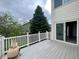 Back deck with white railings offers outdoor entertaining space with views of the yard and surrounding trees at 20532 E Lake Cir, Centennial, CO 80016