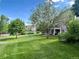 Sprawling green backyard featuring mature trees and lush lawn provides a peaceful outdoor retreat and scenic views at 20532 E Lake Cir, Centennial, CO 80016