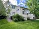 Backyard featuring a well-maintained lawn and a two-story home, creating a serene and inviting outdoor space at 20532 E Lake Cir, Centennial, CO 80016