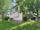 Backyard of home featuring lush green lawn, mature trees, and meticulous landscaping at 20532 E Lake Cir, Centennial, CO 80016