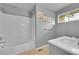 Clean, bright bathroom with a tub, shower, and single sink vanity at 20532 E Lake Cir, Centennial, CO 80016