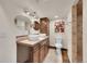 Bathroom featuring double sinks, a separate water closet, and a tiled walk-in shower at 20532 E Lake Cir, Centennial, CO 80016