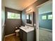 Bathroom with neutral gray walls and floor, white cabinets and window with natural light at 20532 E Lake Cir, Centennial, CO 80016