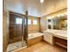 Bright bathroom featuring a glass shower, soaking tub, and dual vanity at 20532 E Lake Cir, Centennial, CO 80016