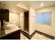 Bathroom featuring modern vanity with vessel sinks, walk-in shower with glass door, and stylish tile work at 20532 E Lake Cir, Centennial, CO 80016
